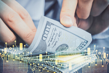 Double exposure of technology drawing hologram and us dollars bills and man hands. Data concept