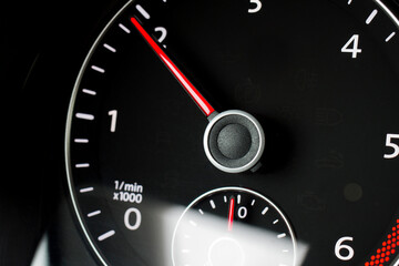 Close-up of a black tachometer in a car