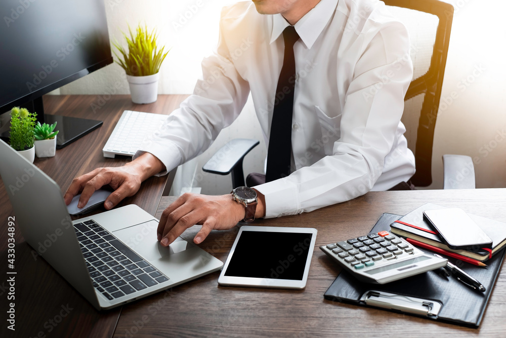 Poster shot of man hand using and typing keyboard of laptop computer on office desk. workspace, businessman