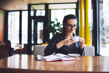 Glad woman drinking coffee during break