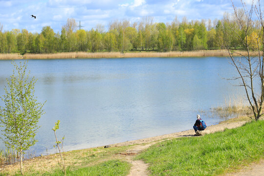 A man is looking to Lake (Gravel pit) and arken mountains (Arkenberge), the highest mountains from Berlin, Germany