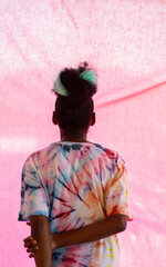 Young black girl in tie dye, rear view