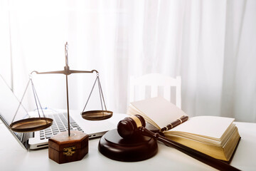 Business and lawyers discussing contract papers with brass scale on desk in office. Law, legal services, advice, justice and law concept picture with film grain effect