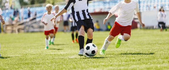 Obraz na płótnie Canvas Group of Boys Playing Football League Match. Football Players Running on Tournament Game