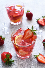 Strawberry lemonade with ice and mint, top view. Cold drink with strawberries.