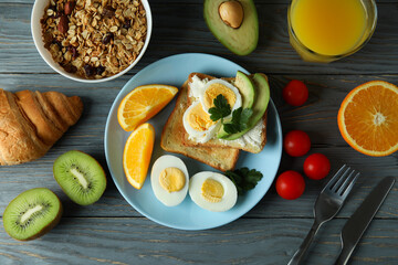Concept of tasty breakfast on wooden background, top view