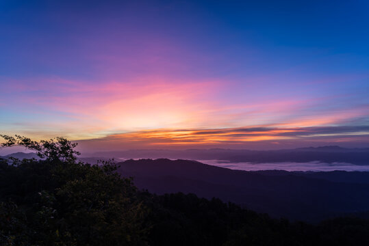 morning view with twilight sky on the top of the mountain names Doi swang or Phu Snan, Doi Phu Kha national park, Nan Province along the Luang Prabang Range in North Thailand