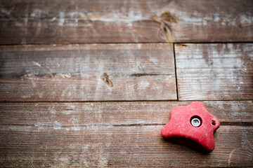 climbing grip handle on wooden background