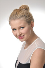 Young happy attractive girl posing in studio . Nice long-haired blonde beauty .