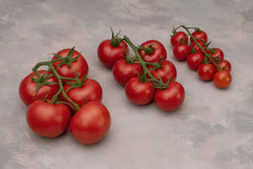 A group of different tomatoes on a dark gray background.