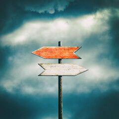 Wooden Sign with arrows pointing in different directions. Path selection concept. Making the right decision. The right direction. Square orientation. Close-up. Business.