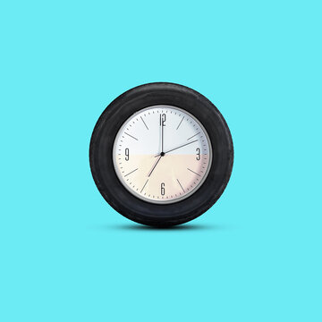 Clock in an auto wheel isolated on a blue background. Time concept. Business. Lifestyle.