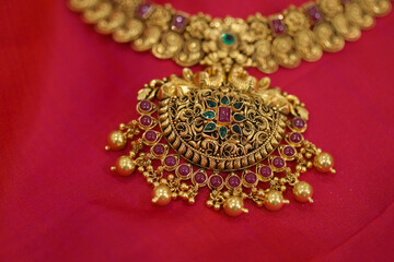 close up of gold necklace on silk