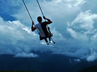 Fototapeta na wymiar man flying on a swing