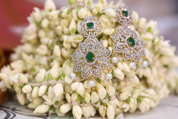 diamond earring on a flower backdrop