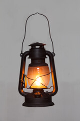 Fototapeta old vintage rusty kerosene black lamp isoleted on gray background. Glass oil lamp. Storm lantern. object vintage concept obraz