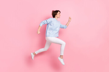 Fototapeta na wymiar Full size profile side photo of happy cheerful good mood lovely girl running in air isolated on pink color background