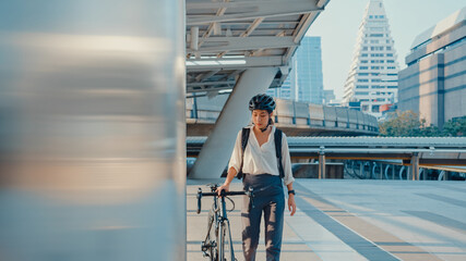 Asian businesswoman go to work at office walk and smile wear backpack look around take bicycle on...