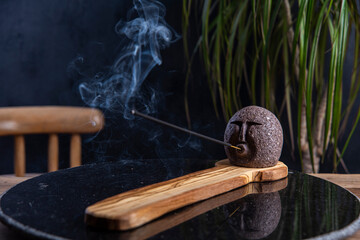 incense with smoke on design holder