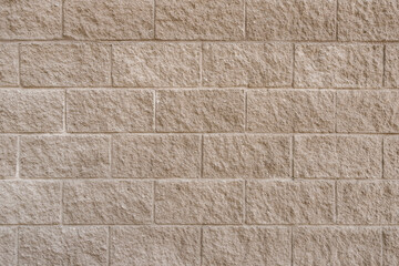 Old gray brick wall of rough stone background