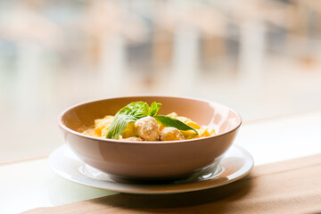 Tagliatelle with rabbit meatballs. Meatballs in a creamy sauce with pasta. Pasta with meat and parmesan cheese. Spaghetti with meat balls and parmesan. Italian pasta for lunch. Pasta in a bowl. Dinner