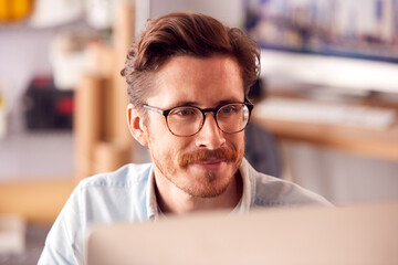 Fototapeta premium Close Up Of Male Architect In Office Working On Desktop Computer Viewed From Behind Screen