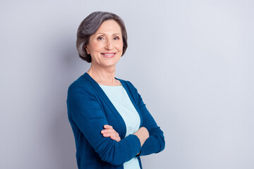 Profile side portrait of attractive cheerful gray haired woman folded arms copy space isolated over grey pastel color background