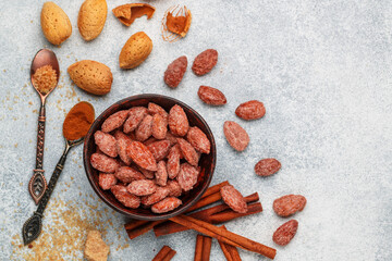 Almond. Crispy roasted almonds in brown sugar with cinnamon. Sugared  (caramelized) nuts in a bowl...