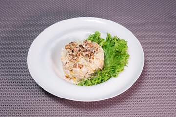 Freshness prepared salad with chicken breast, pineapple and walnuts on the table in a restaurant