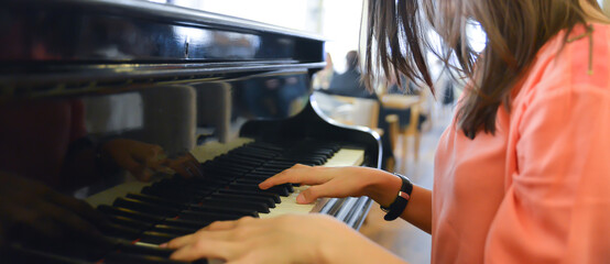 woman playing piano in a bar © marchevcabogdan