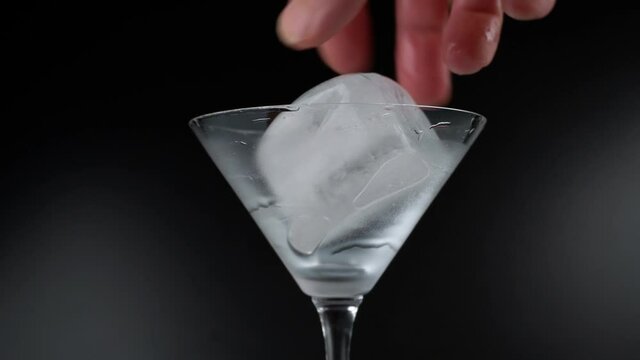 Twirling Clear Ice Cube Isolated on Black Background
