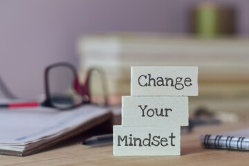 Change Your Mindset inscription. State of mind motivational message on painted wooden chips placed on office desk. Selective focus.