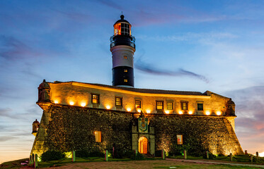 Image of the Farol da Barra lighthouse during sunset in summer at Salvador city, Bahia, Brazil