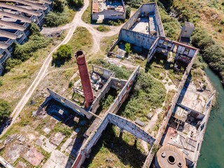 Aerial view of an abandoned building in disuse in the middle of the countryside near the industrial area, Aldeia de Paio Pires, Setúbal, Portugal.