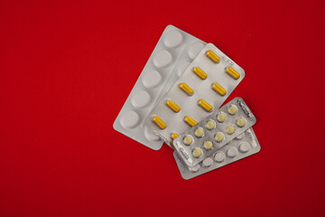 Pills on red background. Healthcare concept