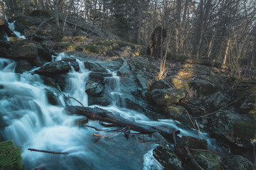Long exposure photo of a beautiful waterfall in the Swedish forest.