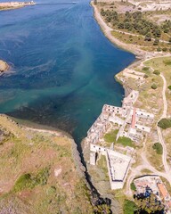 Aerial view of an abandoned building in disuse in the middle of the countryside near the industrial area, Aldeia de Paio Pires, Setúbal, Portugal.