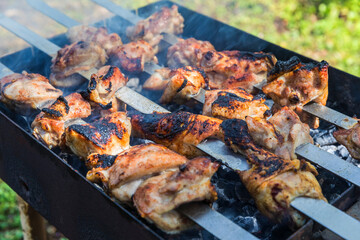 Burnt chicken kebab on the grill