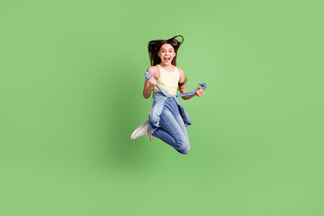 Full size portrait of excited carefree pupil open mouth arms hold touch tie front isolated on green color background