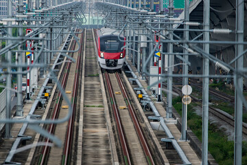 Electric train  red-white  color  on railway in Bangkok, Thailand. New  Electric train in Bangkok, Thailand.