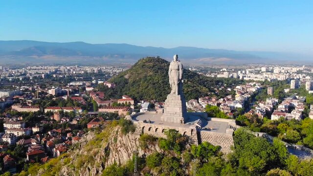 Alyosha Monument, Plovdiv, Bulgaria. 36 foot tall reinforced concrete statue of a Soviet soldier on Bunarjik Hill. Beautiful scene of city took with aerial drone 4K 30fp