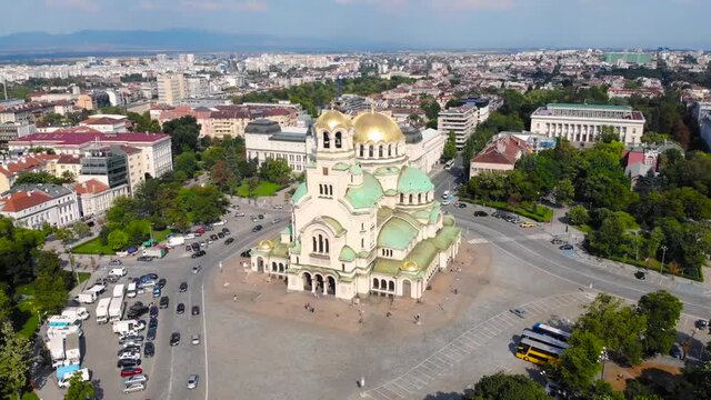 Alexander Nevsky Cathedral, Sofia, Bulgaria. Orthodox church built in Neo-Byzantine style and city view. Beautiful scene of byzntine religion building took with aerial drone 4K 30fps.