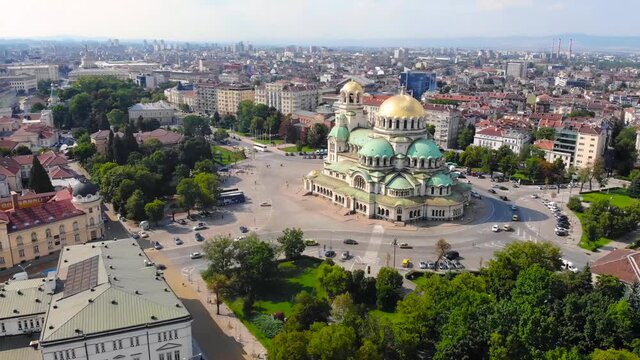 Alexander Nevsky Cathedral, Sofia, Bulgaria. Orthodox church built in Neo-Byzantine style and city view. Beautiful scene of byzntine religion building took with aerial drone 4K 30fps.