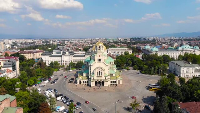 Alexander Nevsky Cathedral, Sofia, Bulgaria. Orthodox church built in Neo-Byzantine style and city view. Beautiful scene of byzntine religion building took with aerial drone 4K 30fps.