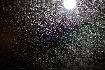 Blurred background with raindrops and lights.