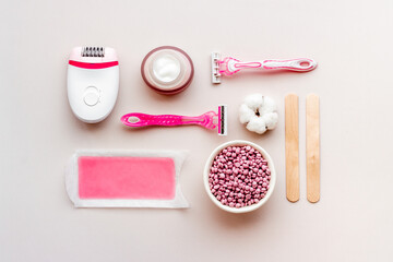 Cosmetics set for epilation with epilator and wax strips and flowers. Top view