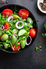 salad olive fruit vegetable olives tomato cucumber, lettuce mix leaves snack keto or paleo diet meal diet vegan or vegetarian food copy space food background rustic. top view 