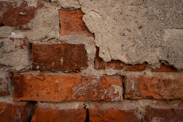 Texture of red old brick with fragments of cement. Old wall background