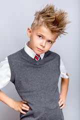 Funny cute little boy in elegant school clothing	