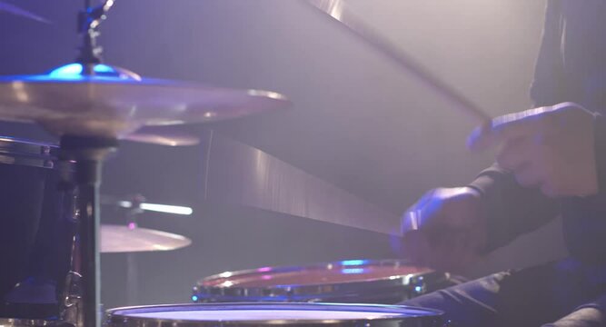 Close-up of male hands playing the drums